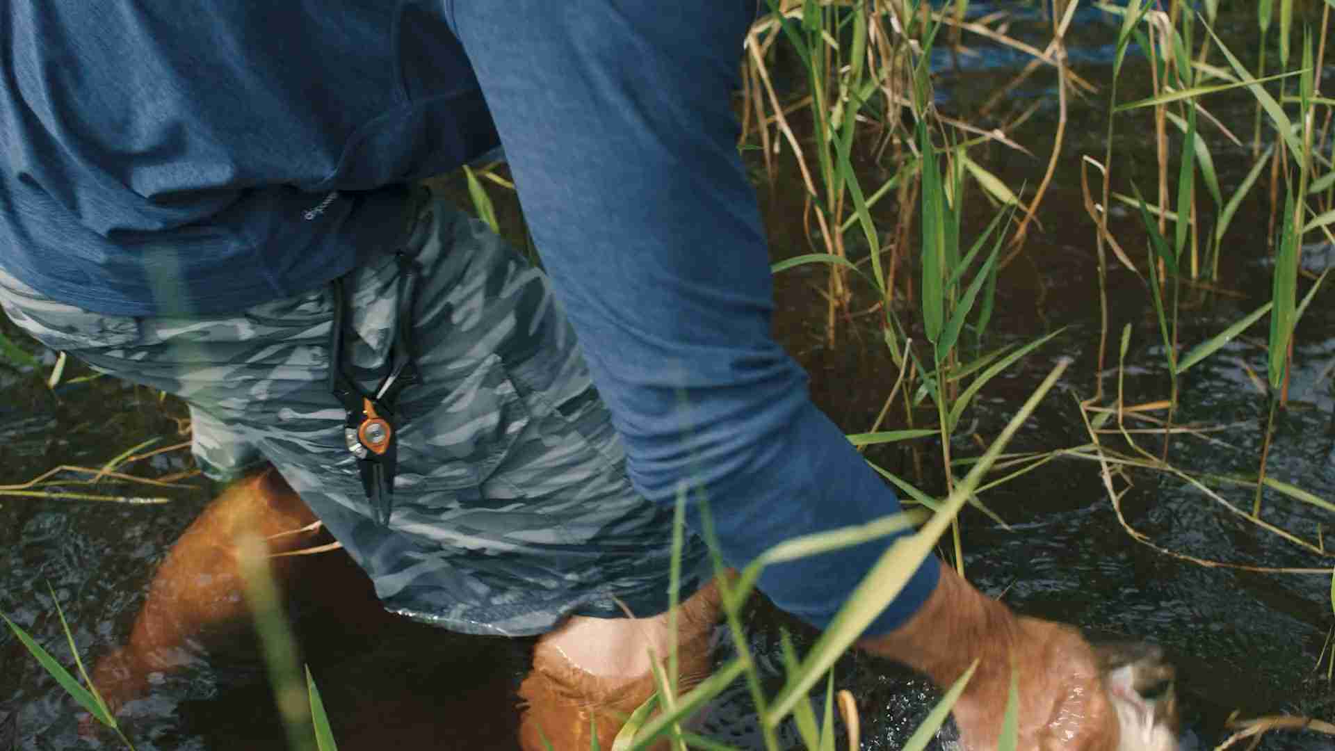 A man pulling a fish out of the water